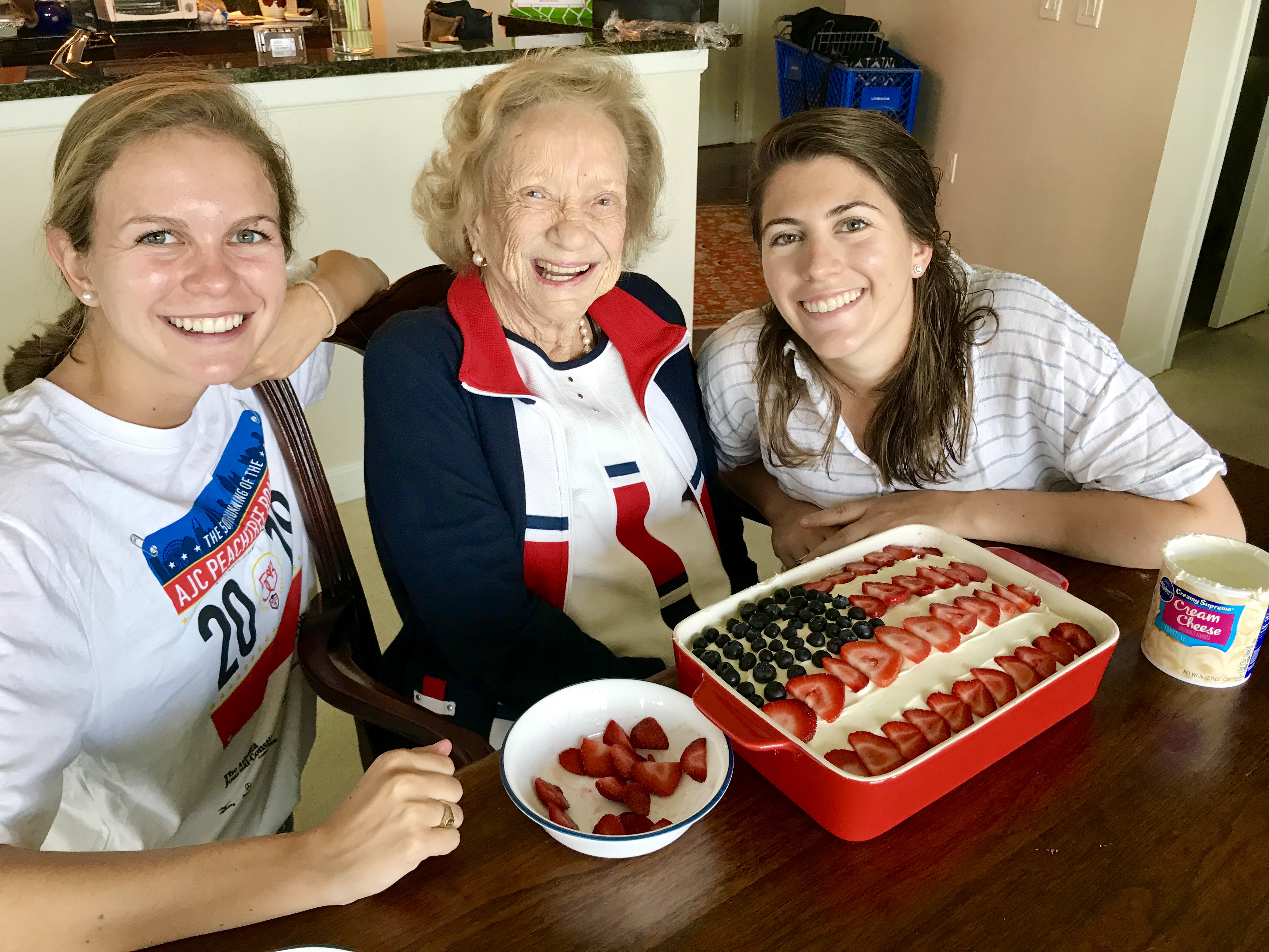 MB, her grandmother, and her sister making an American flag cake